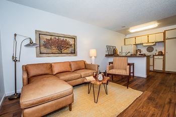 A living room with a brown leather couch and a coffee table.
